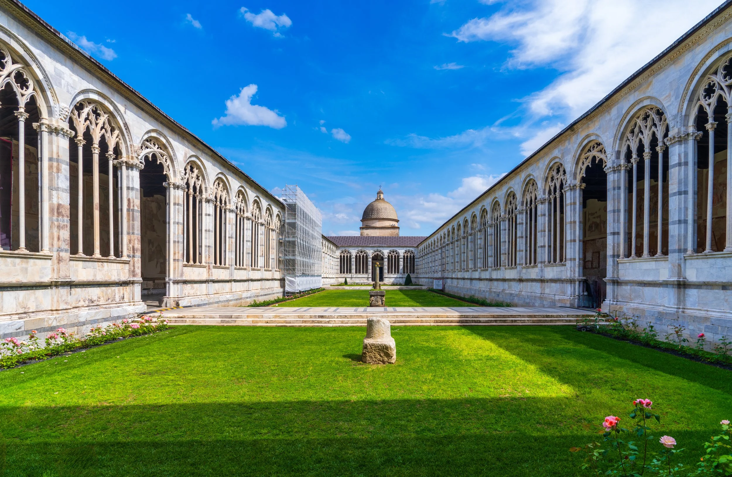 A stunning symmetrical view of the historic cloister at Camposanto Monumentale in Pisa, Italy. Fine art travel and architectural photography showcasing the elegant Gothic arcades, peaceful courtyard, and the timeless beauty of Piazza dei Miracoli, a 