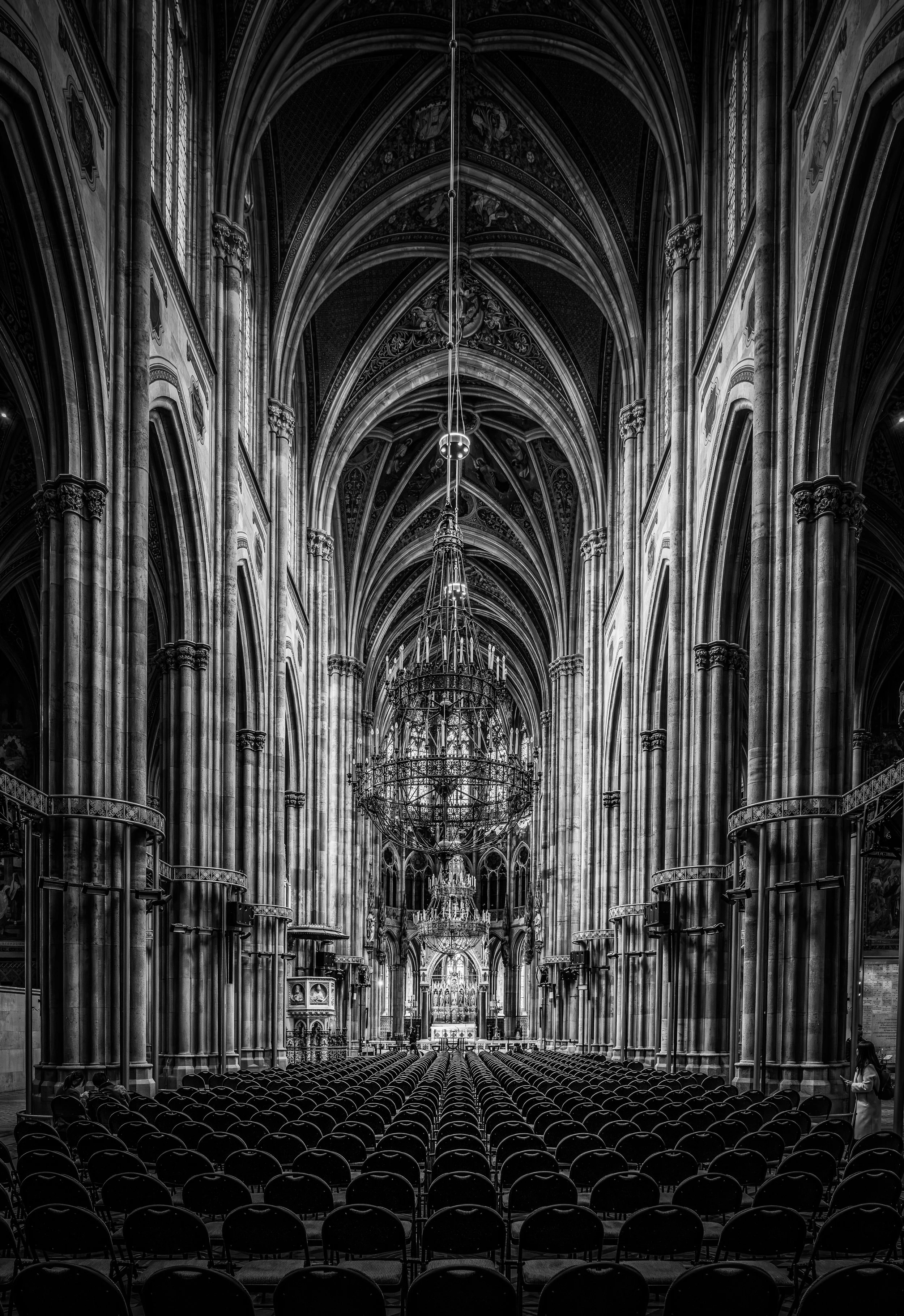 A dramatic black and white photograph of the magnificent interior of St. Stephen's Cathedral (Stephansdom) in Vienna, Austria. Fine art architectural photography showcasing the soaring Gothic arches, intricate details, and timeless beauty of one of E