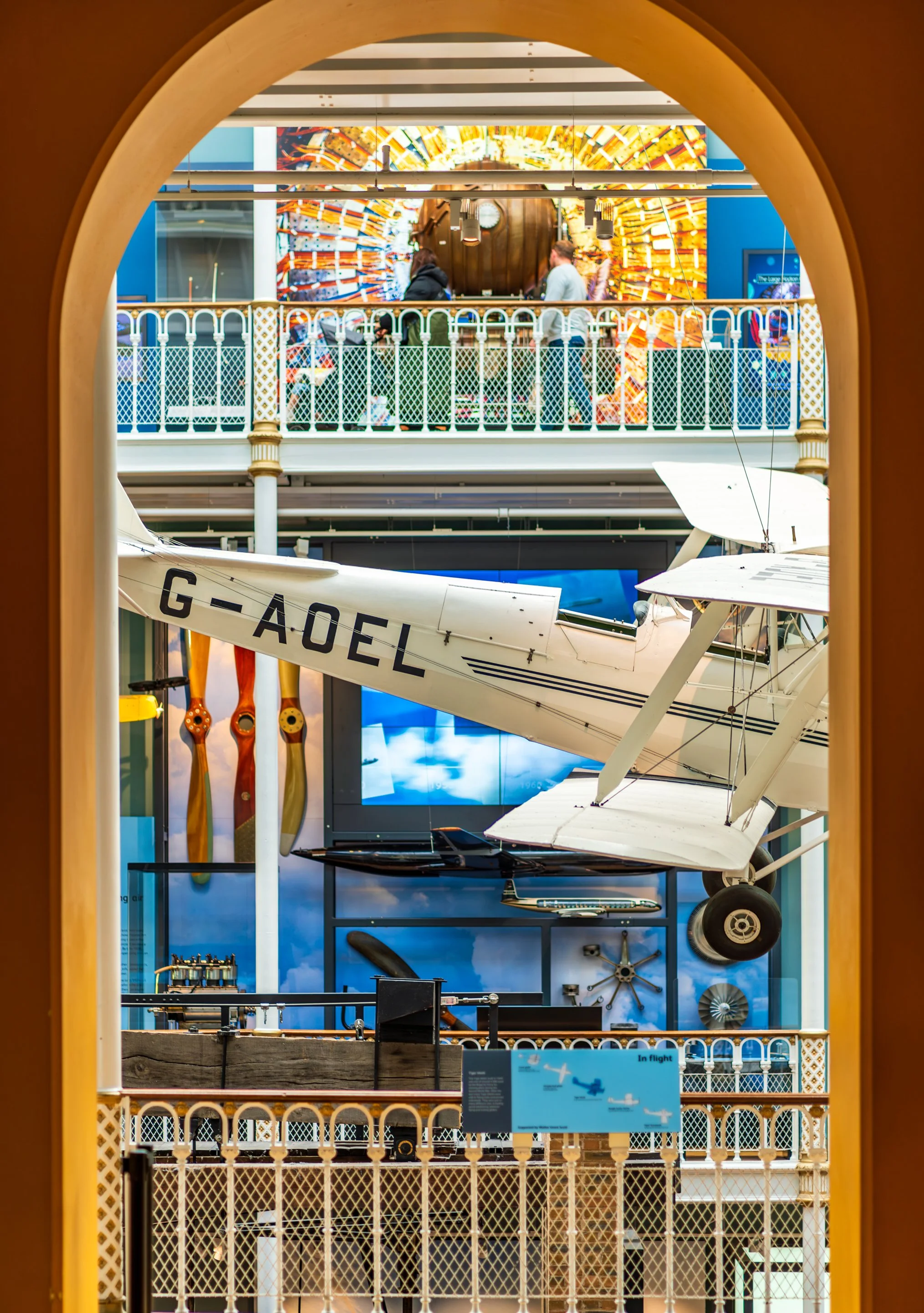 Historic aircraft framed by an arch inside the National Museum of Scotland in Edinburgh.