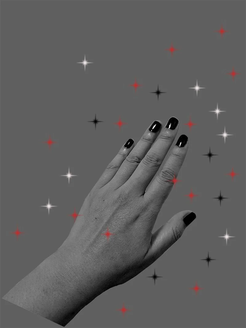 A black-and-white photo of a person's hand with dark nail polish, surrounded by small red, black, and white star-shaped decorations on a gray background.