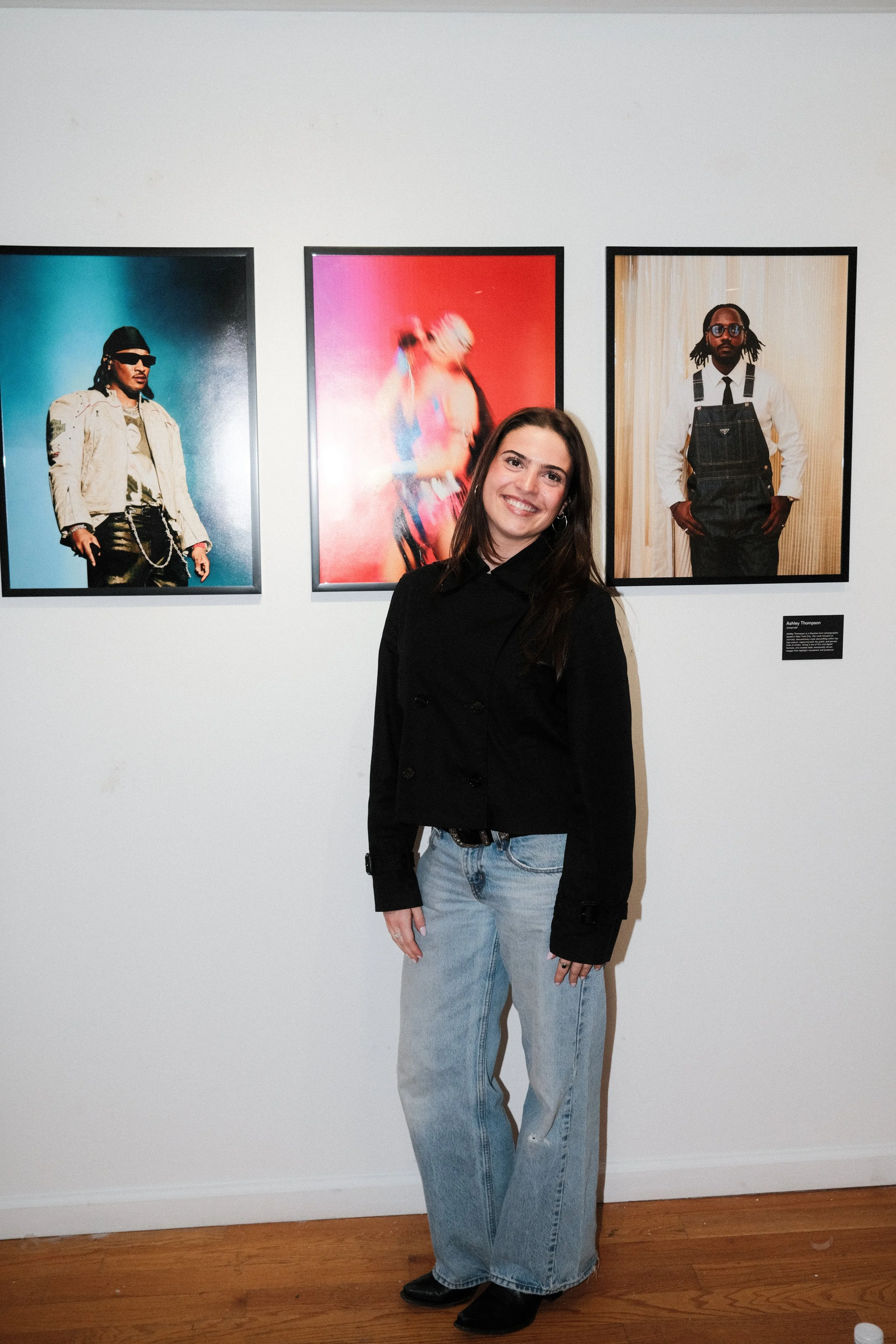 Ashley Thompson in front of her concert photography work at house of jpg gallery event