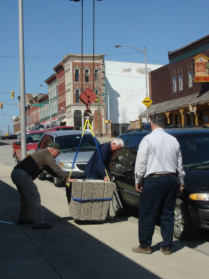 Main Street Volunteers placing Flower Planters on Sidewalks