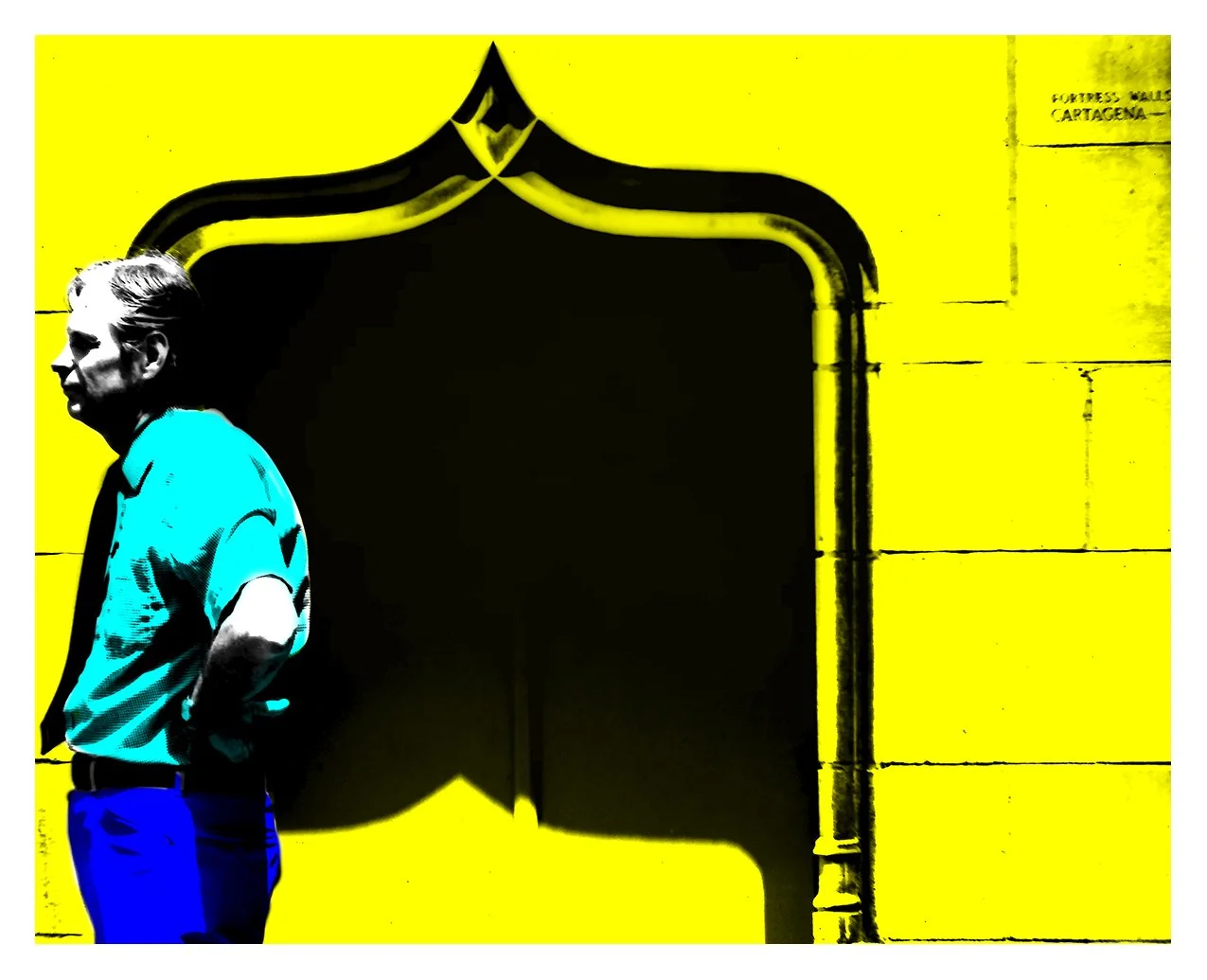 Man in front of a yellow wall