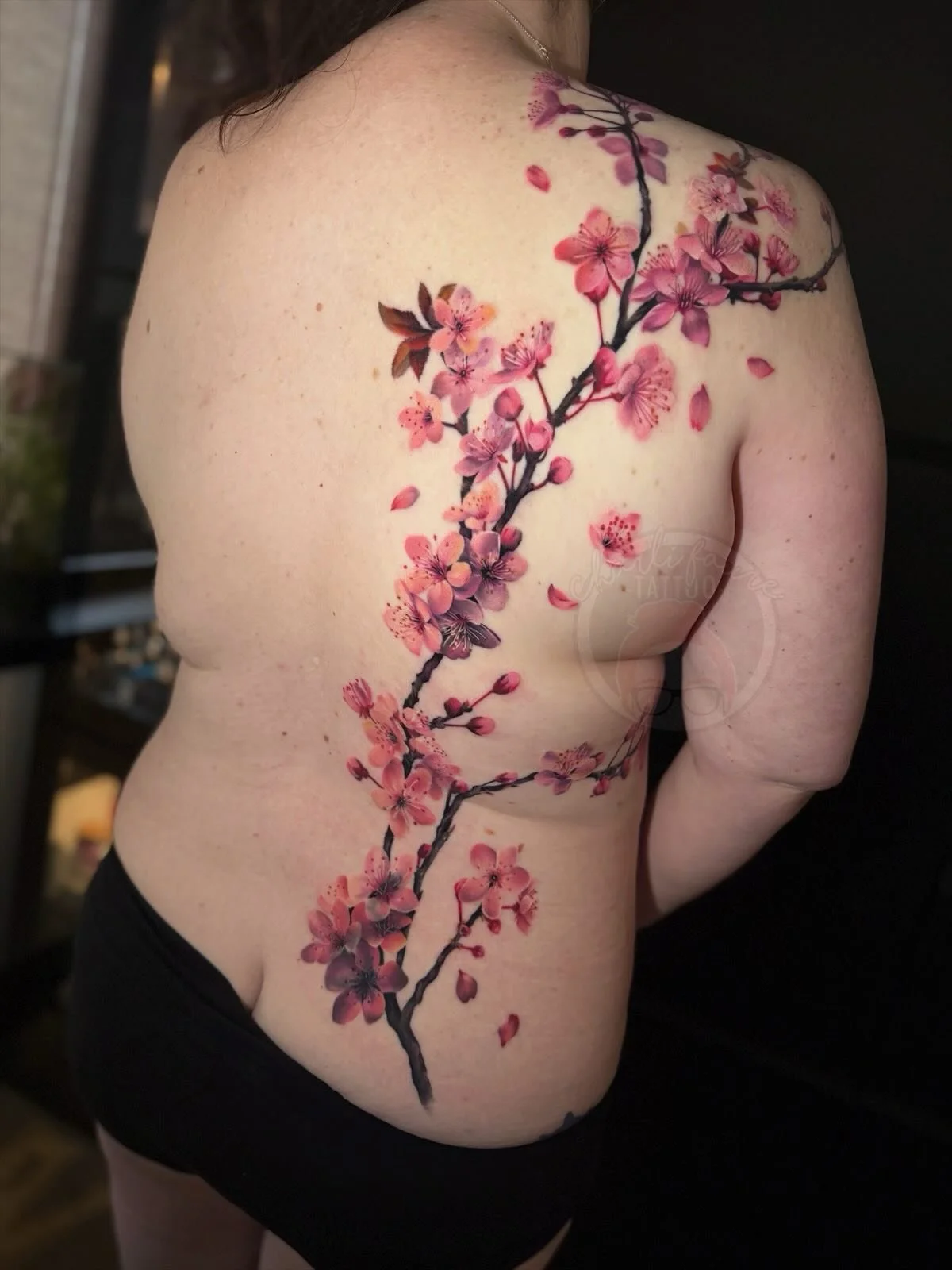 Thanks so much for the trust with another big tattoo Megan. I love how this cherry blossom cover up piece came together. It flows so lovely with her back, ribs and shoulder. I really like how the warm and cool tones make the contrasting colours give 