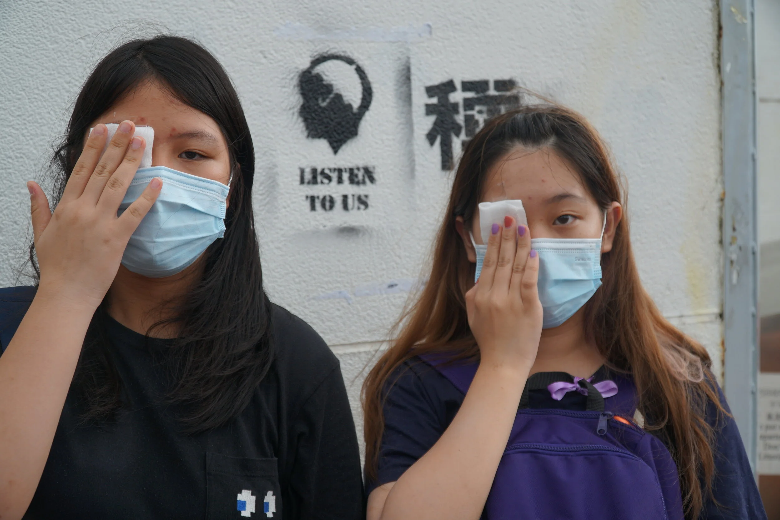 Students wear eye patches to show respect for a nurse who lost her eye during the protests