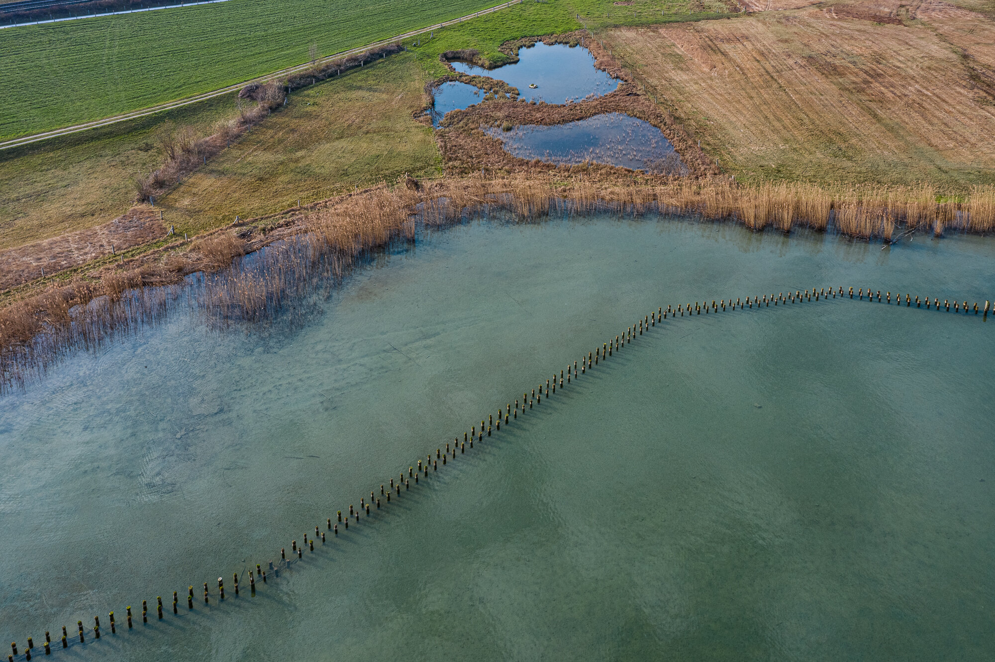  FEELING BLUE. Drone pictures from different hights and angles, merged into one by the line of the stilts. Pfäffikon, Schwyz 