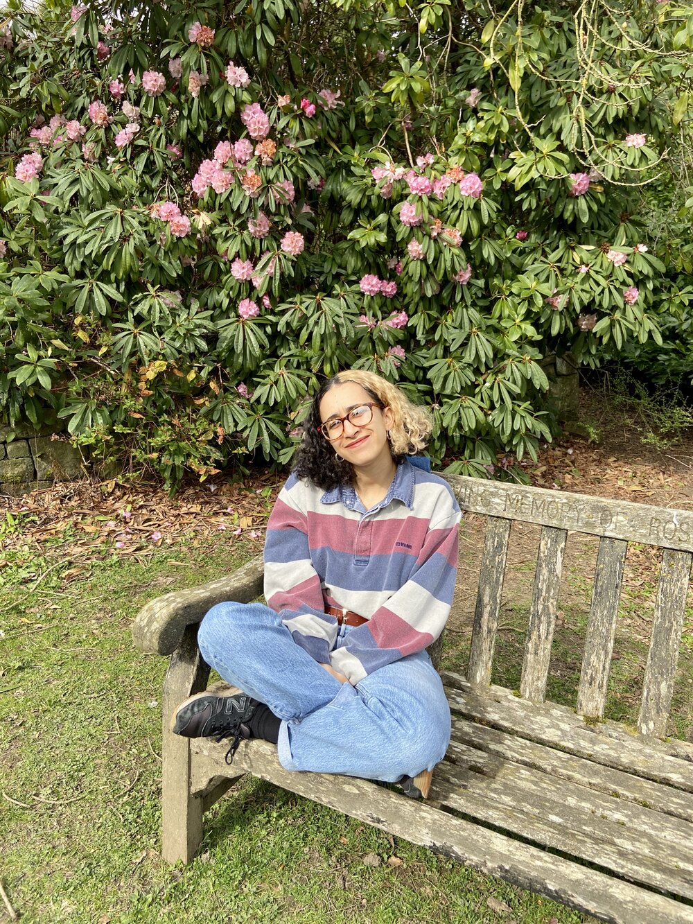 Shahed Ezaydi sitting in front of spring blooms. Photo: Shahed Ezaydi/Lacuna Voices