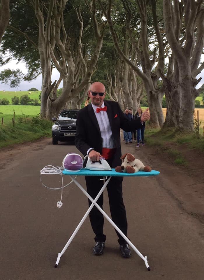 Andy extreme ironing in his tux at The Dark Hedges in Ireland. Photo: Andy Farrer/Belfast News and Features 