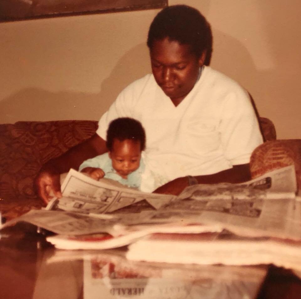 Ken Makin as a baby pictured with his father reading a newspaper. Photo: Ken Makin
