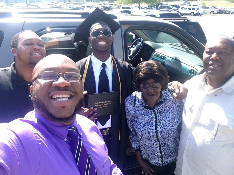 Ken (front) with his brothers, father (right) and grandmother in a joyful family selfie. Photo: Ken Makin