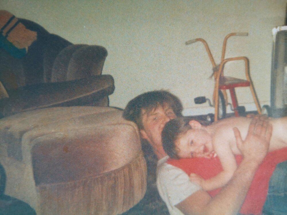 Dan as a baby, cuddling his dad, Nigel. Photo: Dan Hughes