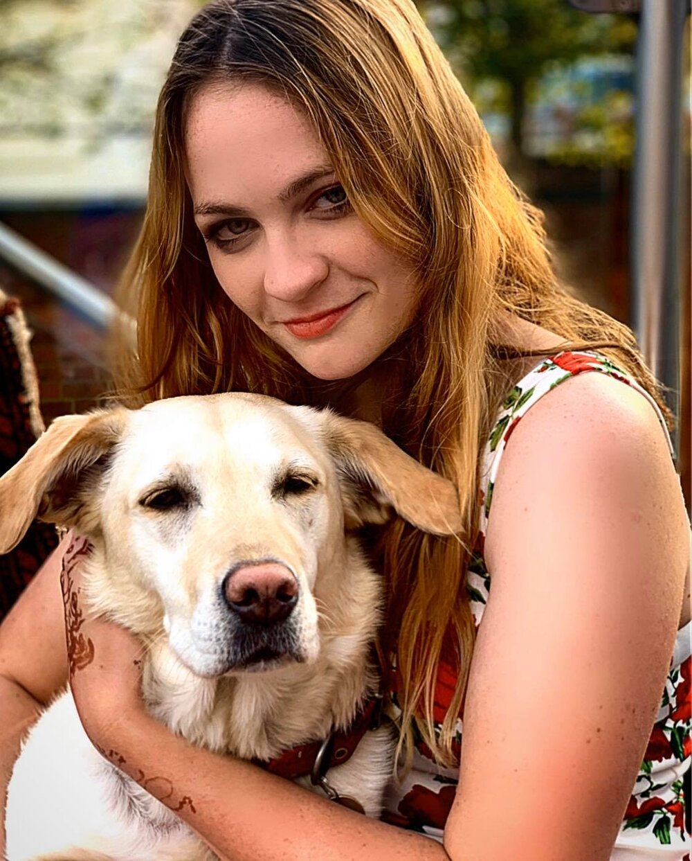 Sophie Brown cuddling a white Labrador. Photo: Sophie Brown/Belfast News and Features