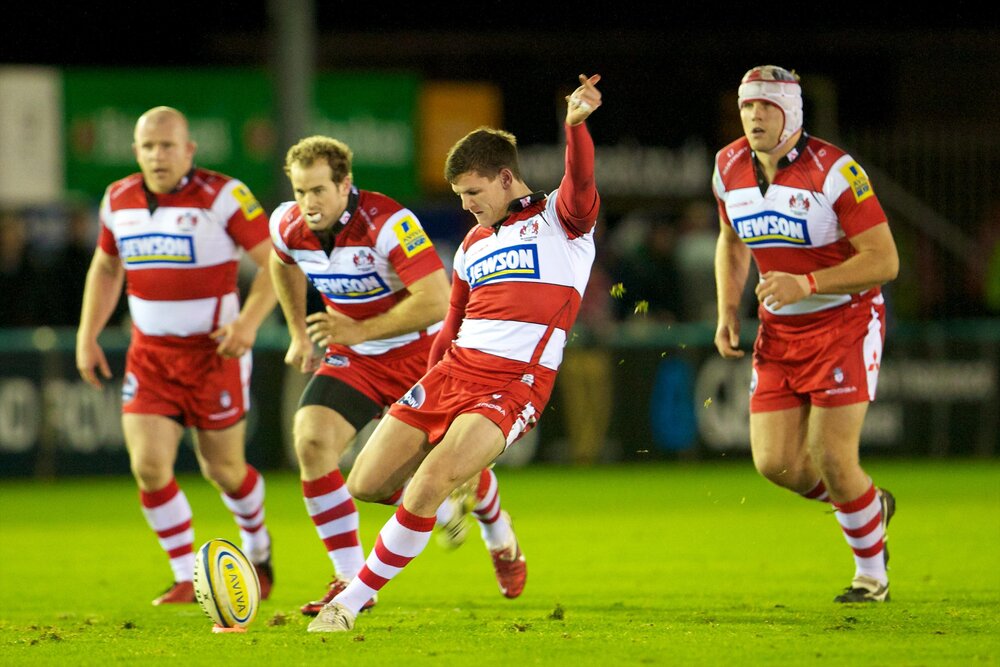 Freddie kicking for Gloucester vs Newcastle in December 2011 as teammates look on. Photo: Action Plus/Alamy Stock Photo