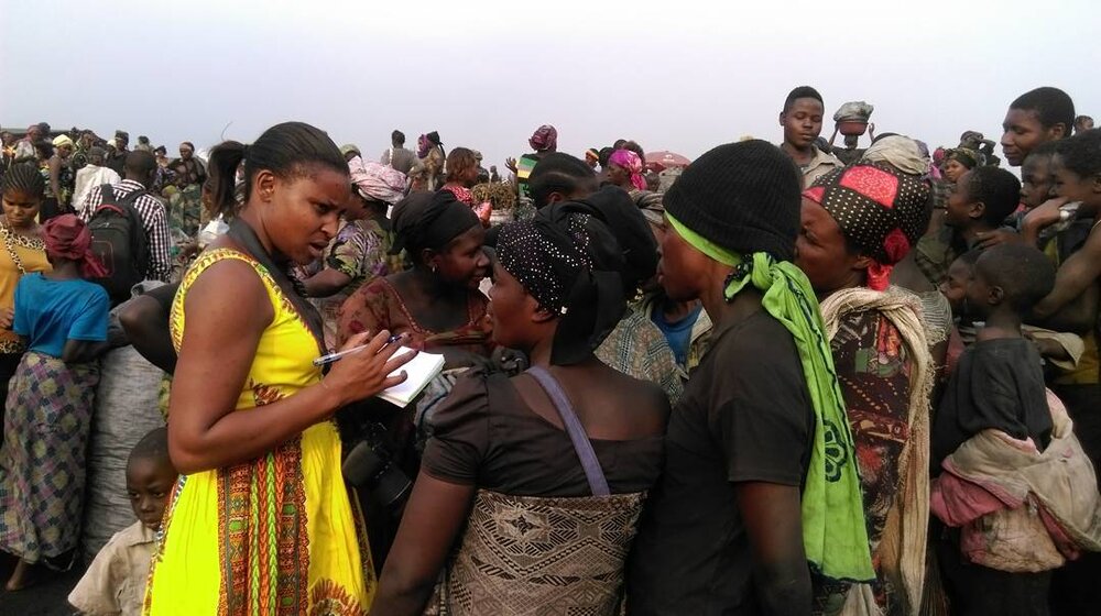 Sophie Mbugua (in yellow) reporting in the Democratic Republic of Congo. Photo: Lili Quo