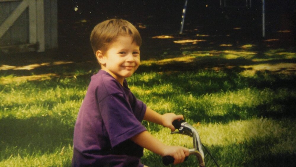 John as a happy little boy, pictured riding his bike in the back yard. Photo: John Marchese