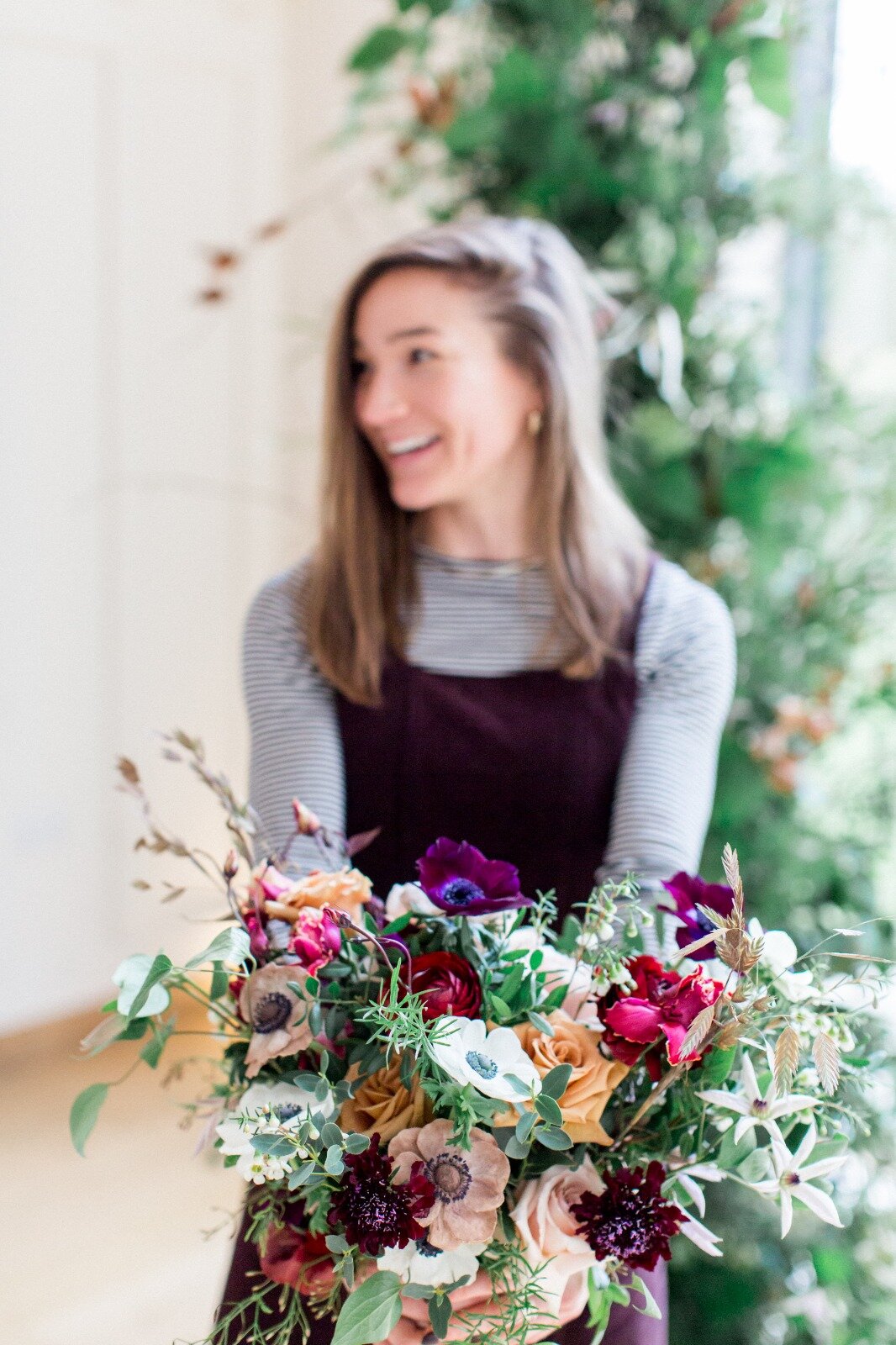 Poppy holding a bouquet she made. Photo: Phillipa Sian Photography
