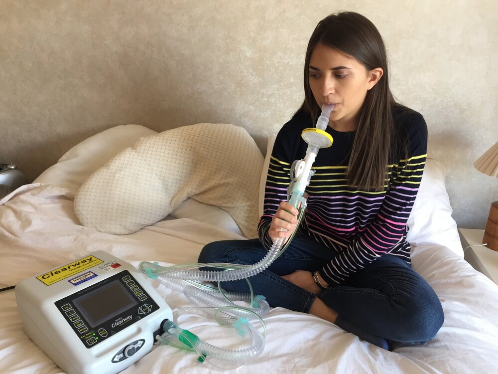 Isabelle is pictured using a medical device to inhale medication for her cystic fibrosis. Photo: Isabelle Jani-Friend