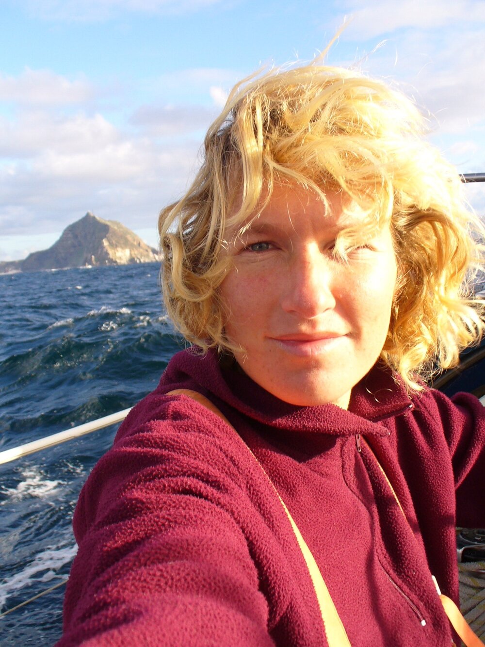 A selfie of Kirsten at sea with the choppy waters in the background and the sun on her face. Photo: Kirsten Neuschäfer