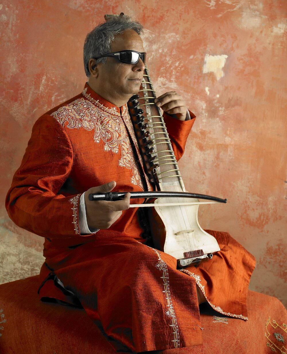 Baluji Shrivastav OBE playing a dilruba. Photo: Lacuna Voices