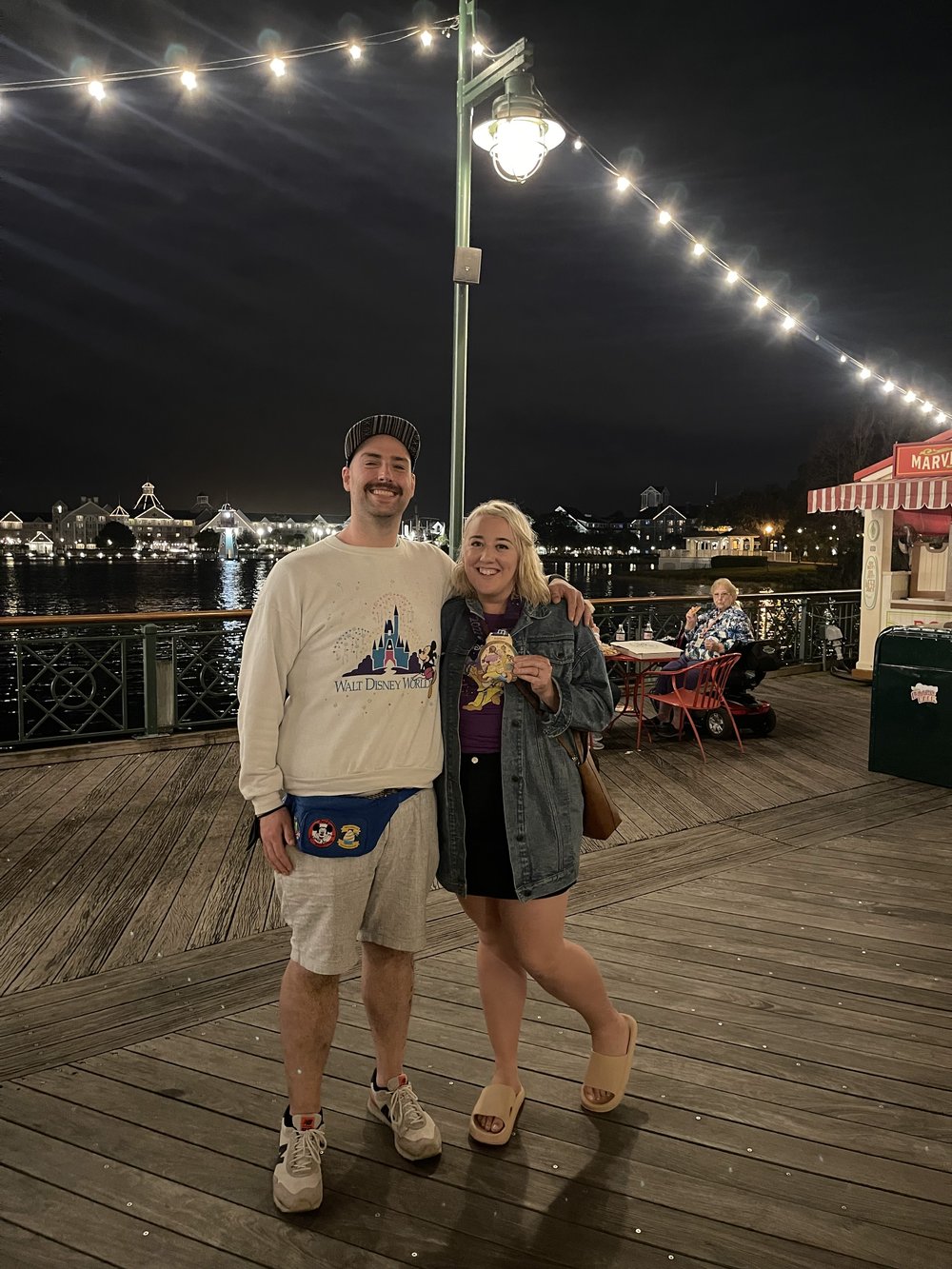 Jennifer and her husband Andy Risi standing on a pier at nighttime in New York after her marathon in January 2022. Photo: Jennifer Risi