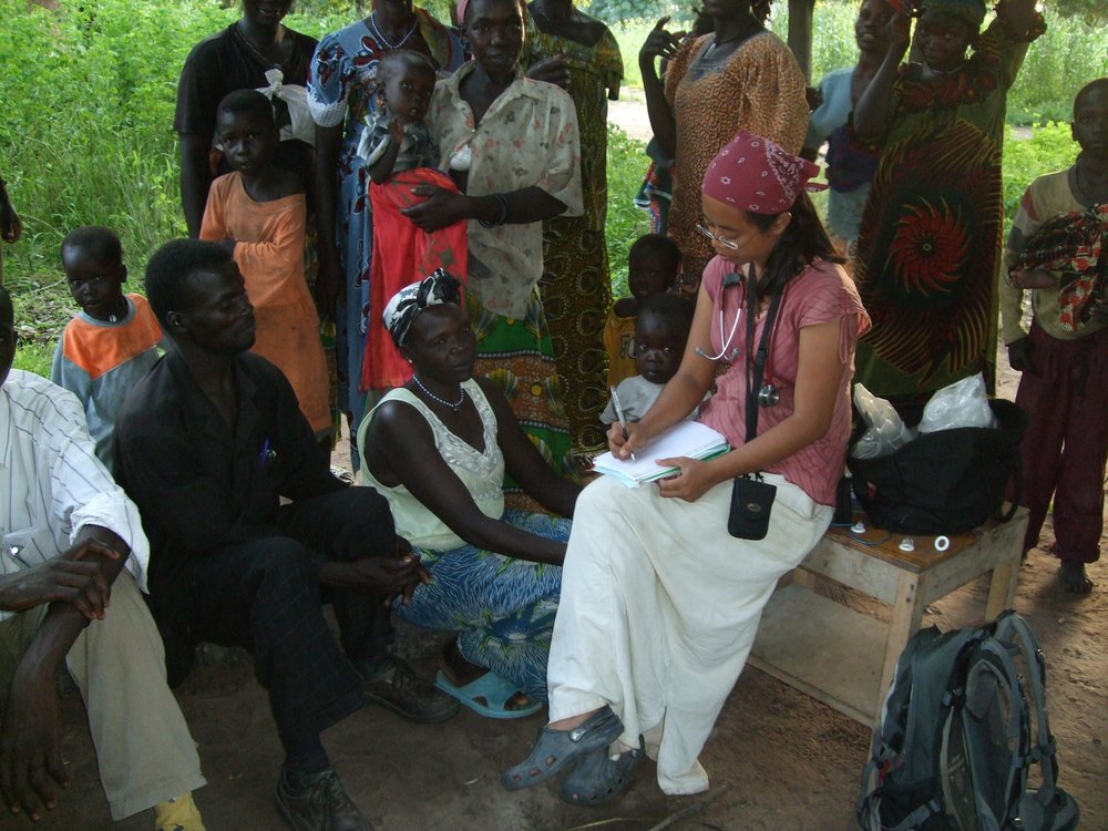 Annie seeing patients after a lecture during a mobile village clinic in Chad, Africa