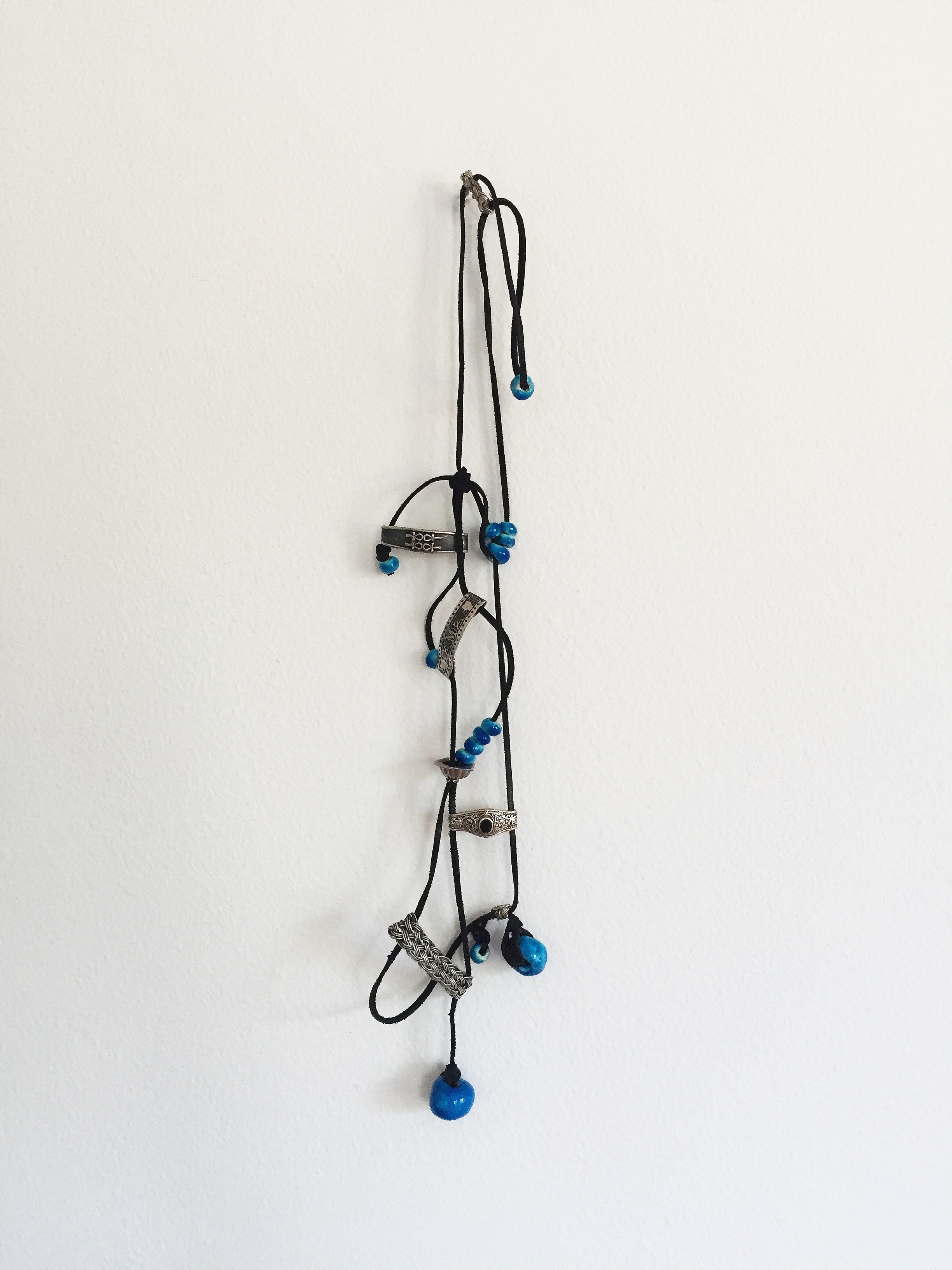   Souvenir , 2016  leather cord, silver rings, ceramic beads 