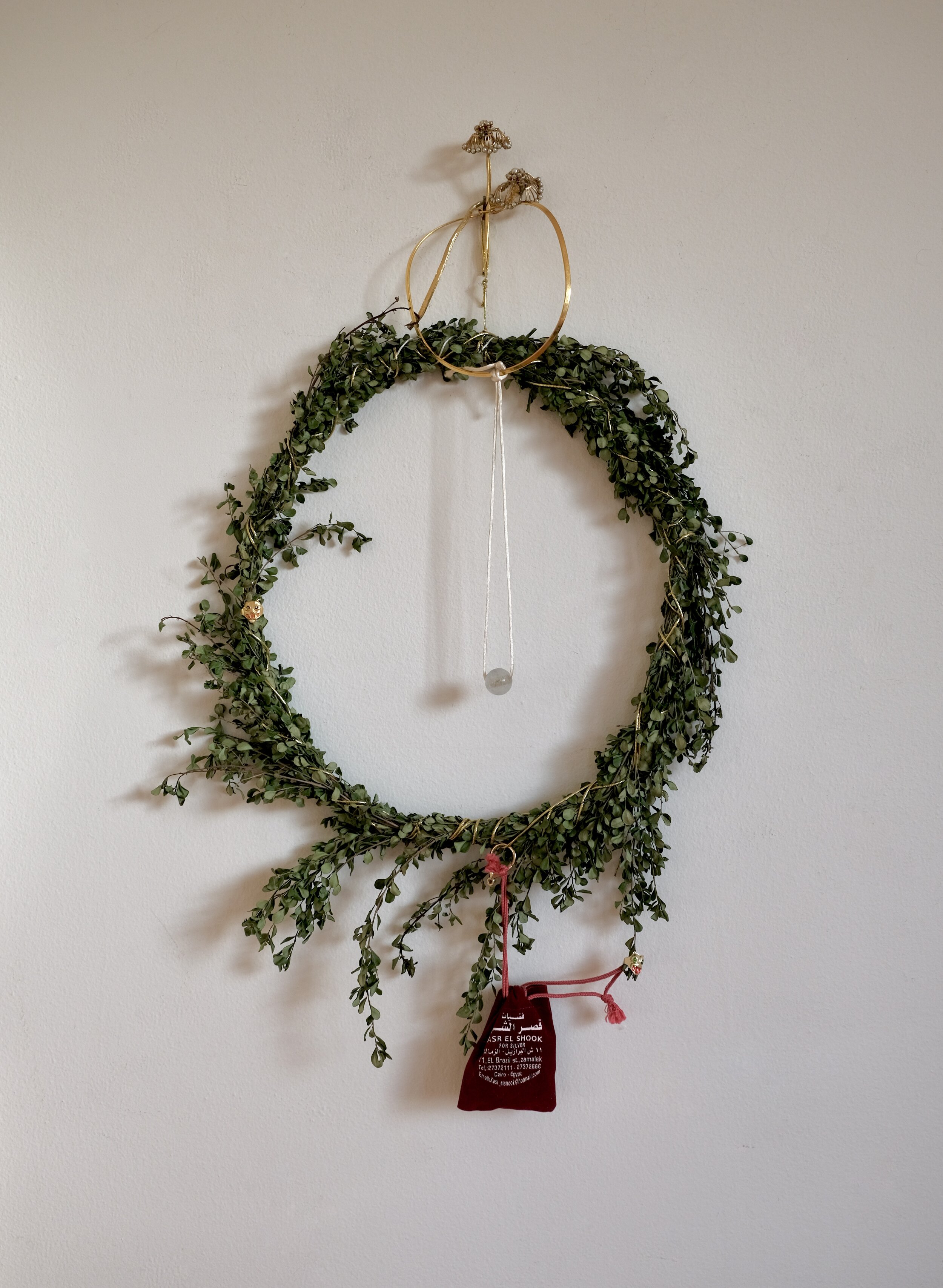  Christmas Wreath , 2020  boxwood branches, gold cord, jewelry parts, jewelry pouch, silk cord, glass, vintage novelty rings 