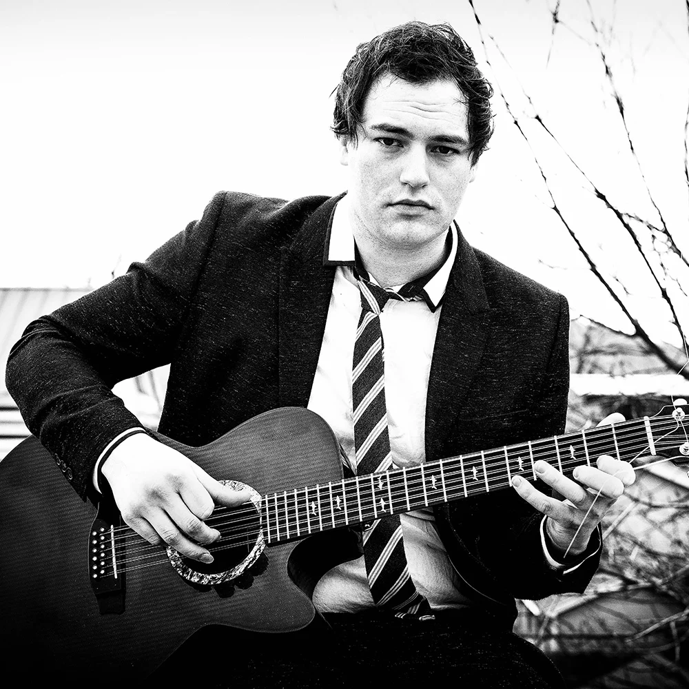 Portrait of Alexander Turnquist with guitar