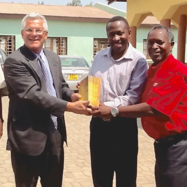 Greg-giving-10-BTCP-manuals-number-1-to-our-Zambian-brothers.jpeg