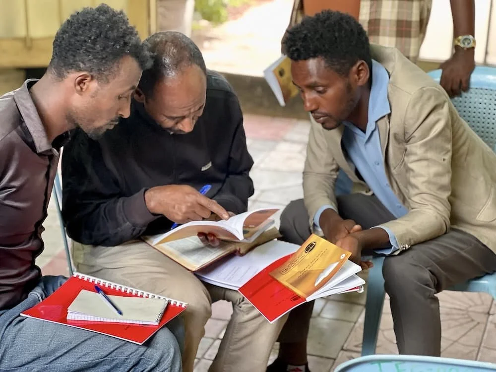 Ethiopian men study the Bible using BTCP Amharic translated curriculum.