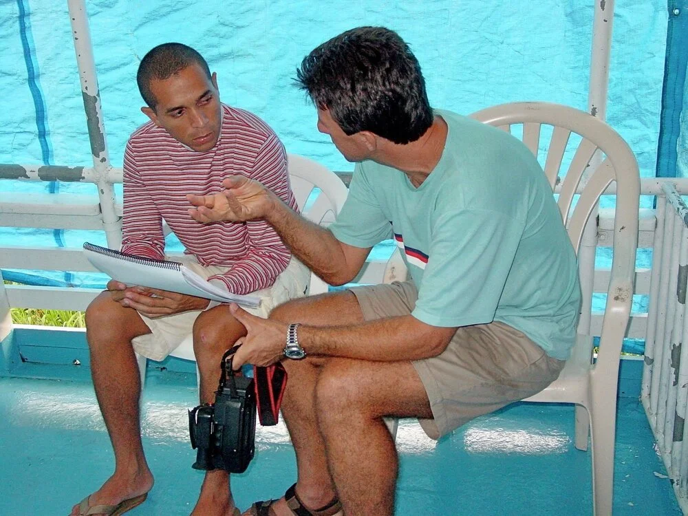 two men talk about a serious biblical issue on a boat