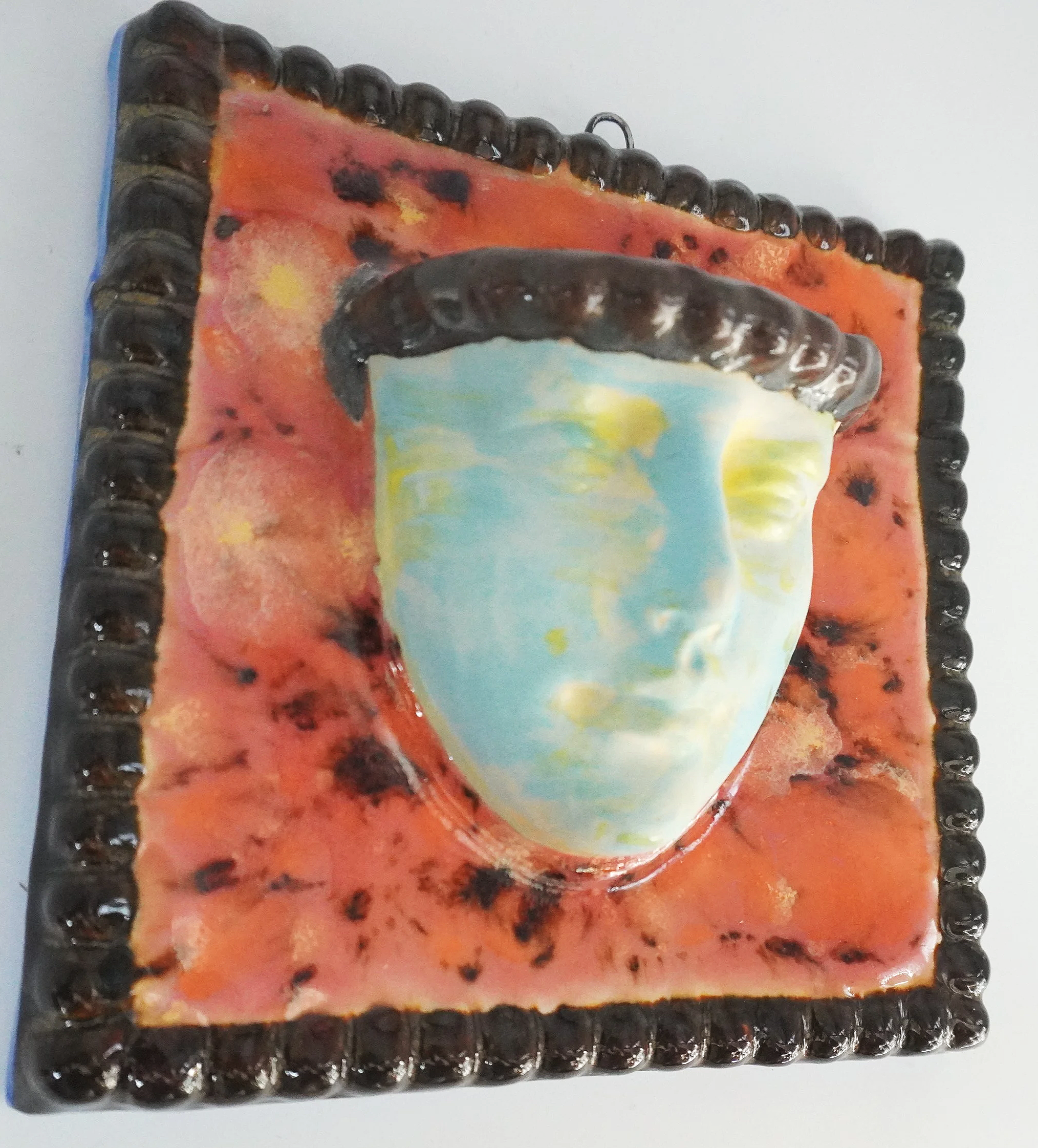 A ceramic face vase formed from an original sculpted model, slipcast and refined by hand. Finished with layered glazes, a square-shaped frame, and a built in water-tight opening for keepsakes.

Medium: Ceramic sculpture
Price: $118.00
Dimensions: 5" 