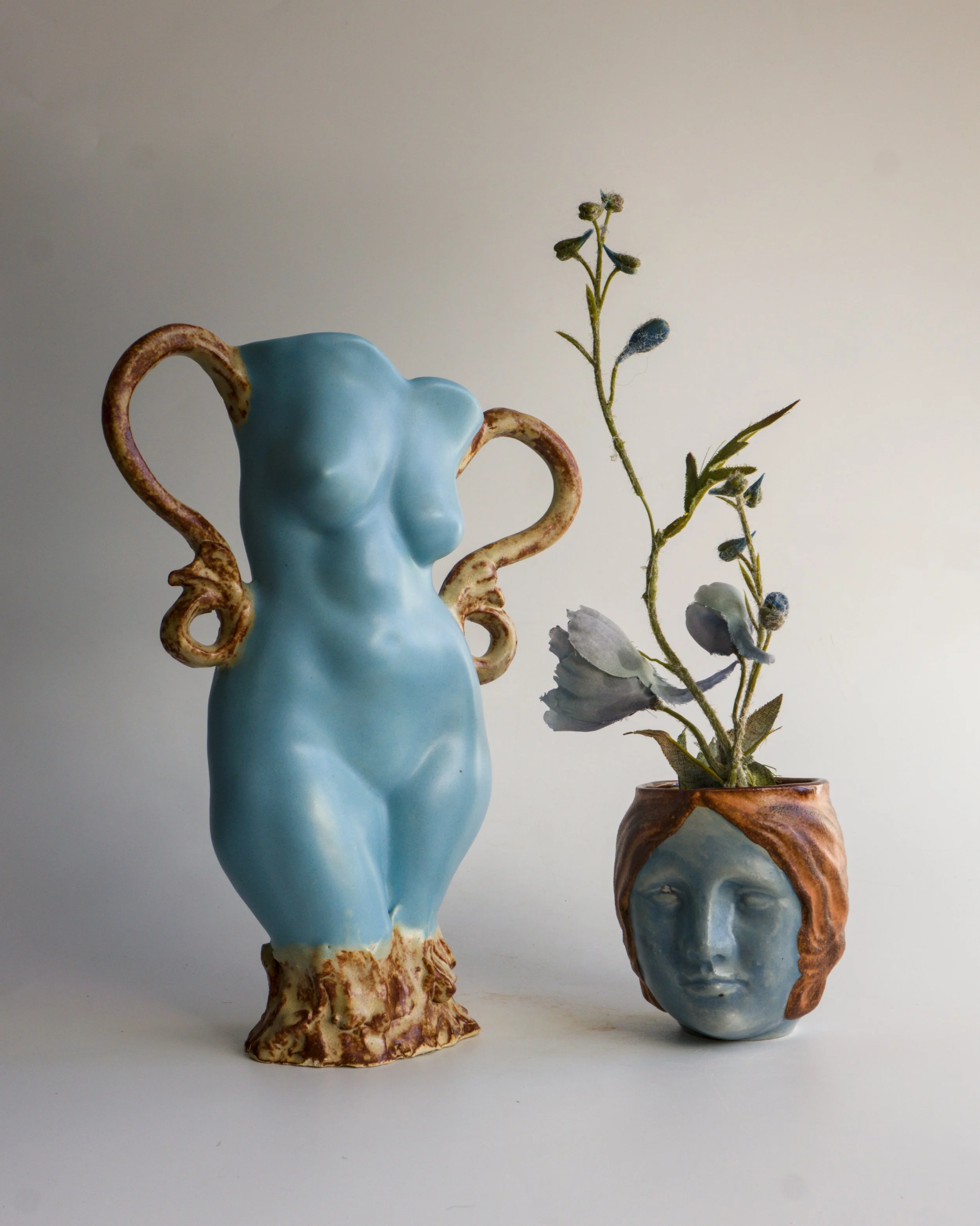 1) Figurative ceramic vessel, satin matte blue glaze, rustic glazed handles, $335
2) Portrait espresso drinking cup, multilayered glazes, $95
