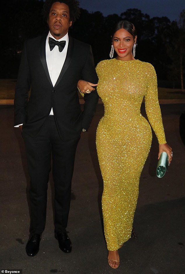 19375176-7544565-Bey_and_Jay_Beyonce_looked_stunning_in_a_glittering_gold_gown_wi-a-34_1570411396128.jpg