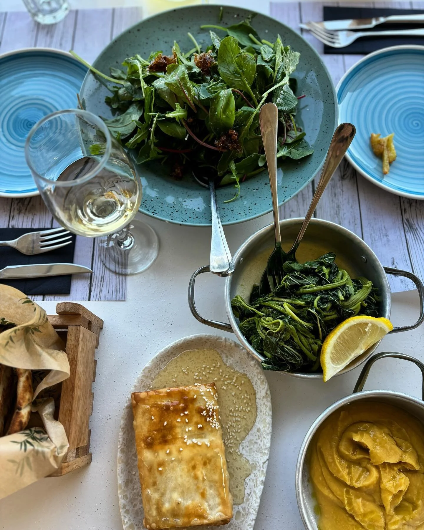 Lunchtime scene in my favourite part of the world. #greece #greekislands #greekfood #lunch #plants #favabeans #wildgreens #greekwine