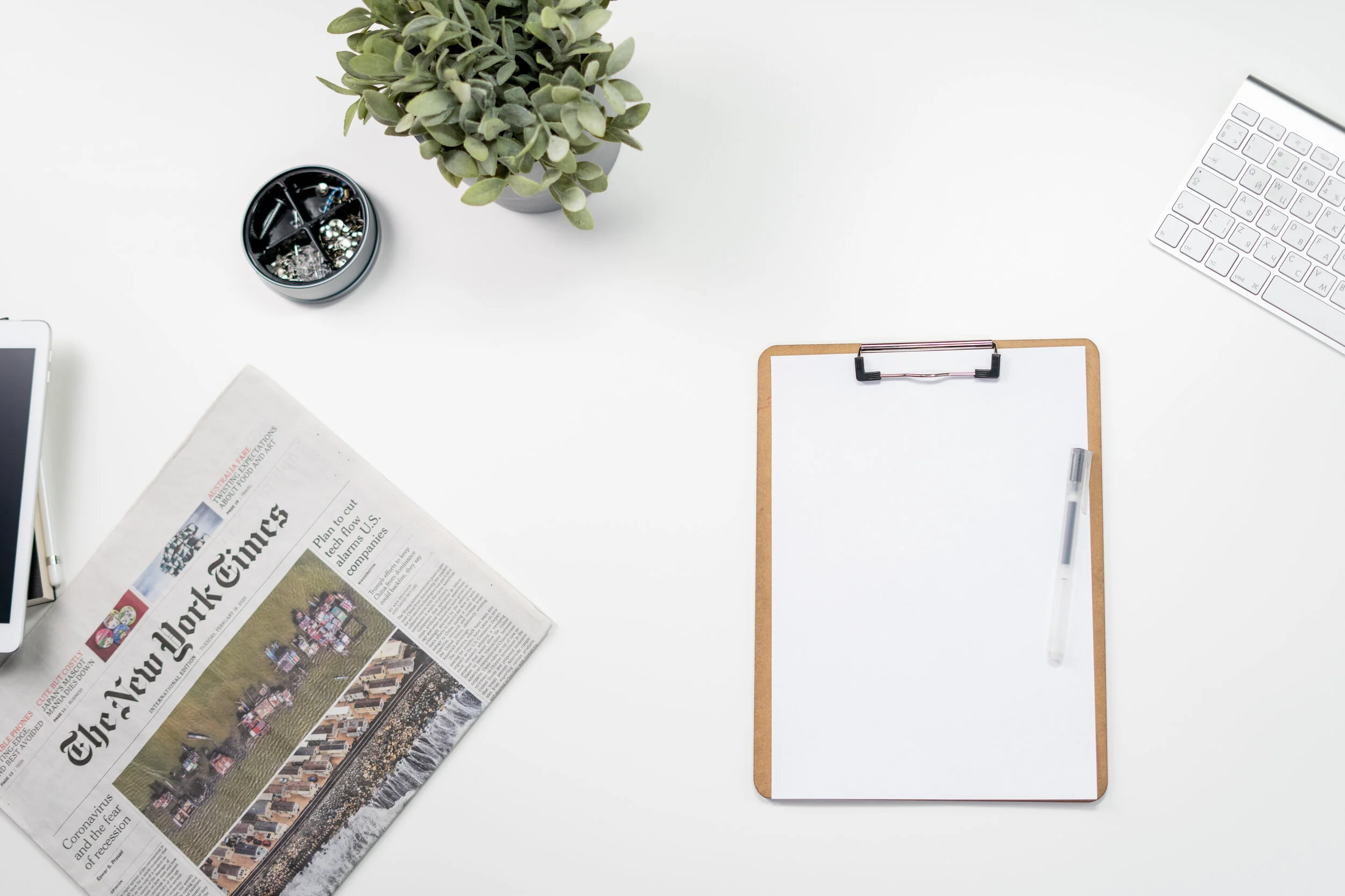 Canva - Clipboard and Newspaper on White Table.jpg