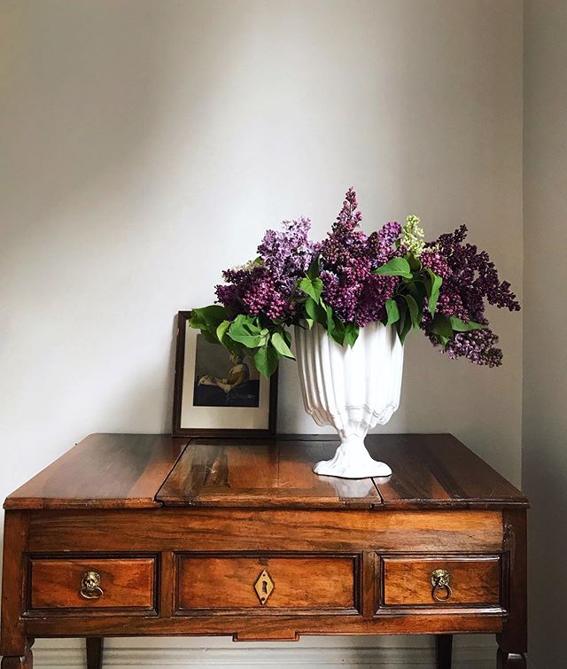 Branches of lilacs bought from plastic buckets. (The ones from Roma women with draping dresses always last longest) A vase , black clay with white glaze in just the right shape. And little lion head drawer pulls that have been bent out of shape over 
