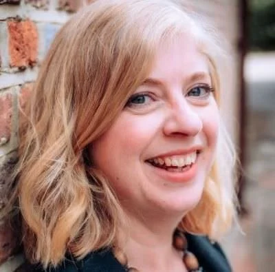 close up of Philippa translator copyeditor against a brick wall