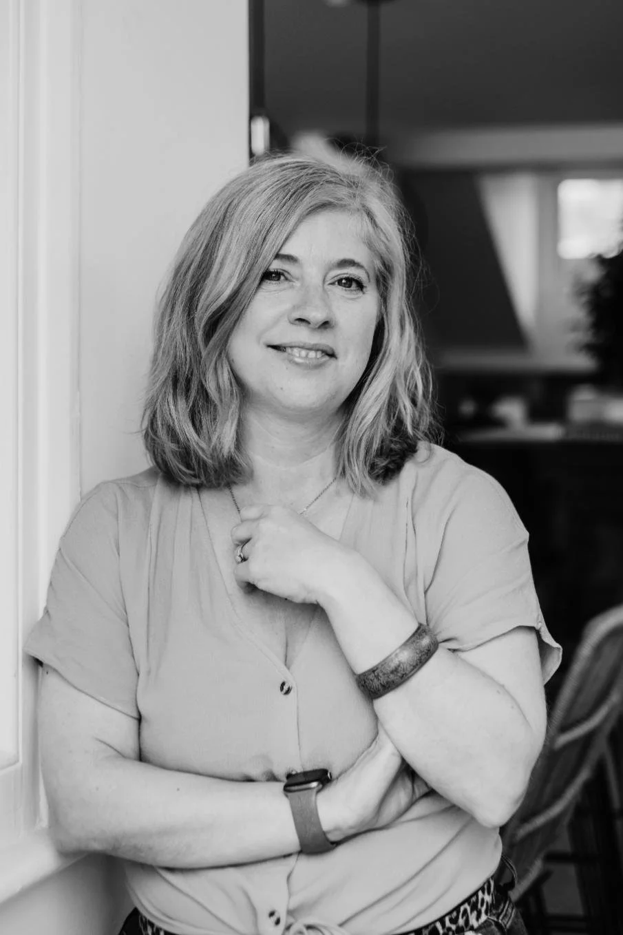 Black and white photo of philippa hammond standing next to a wall