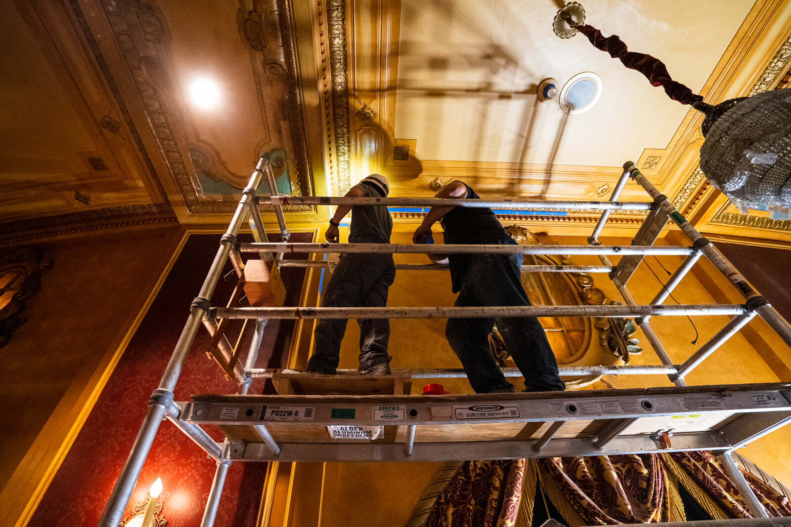  two workers on a scaffold completing restoration plaster work in Sheas theatre, located in downtown Buffalo New York. 