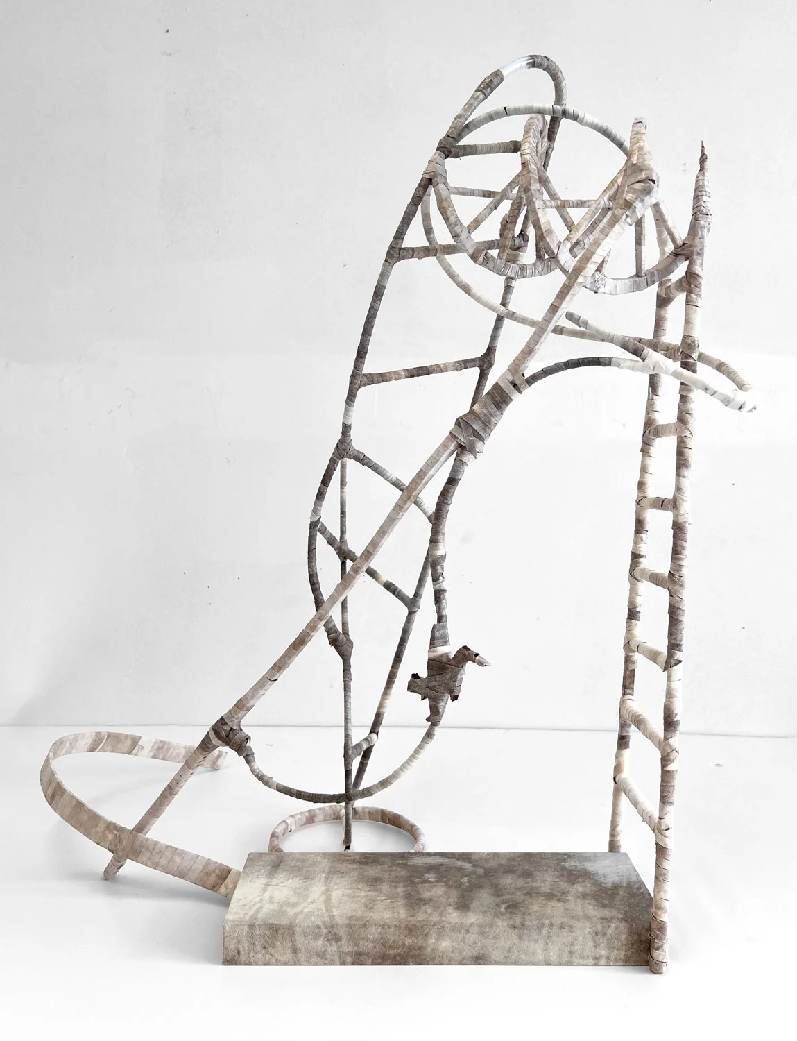 Freestanding wrapped parchment sculpture combining ladder and spiral forms on rectangular base