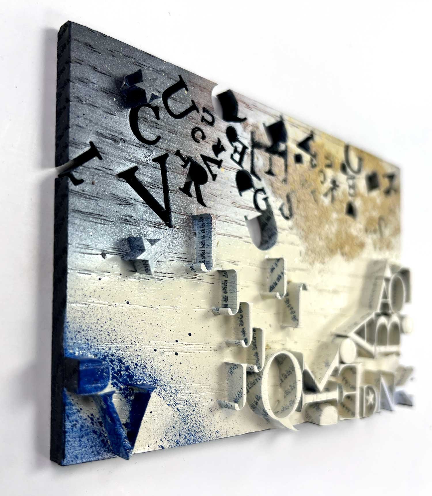 Text based Mixed media wall sculpture with scattered and relief letters in grey, white, and gold, by artist Hodaya Louis