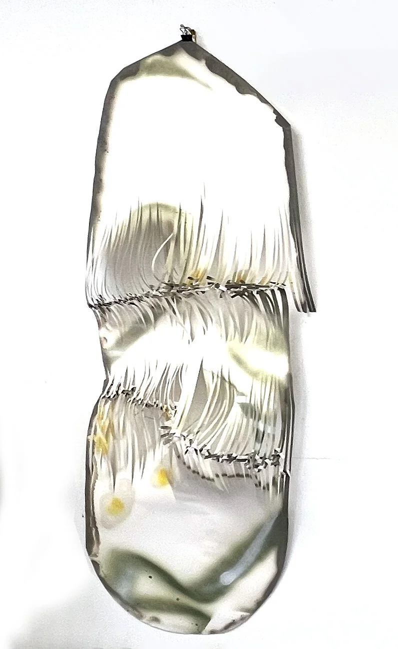 Suspended knotted paper panel with stitched fringe bands hanging against white wall