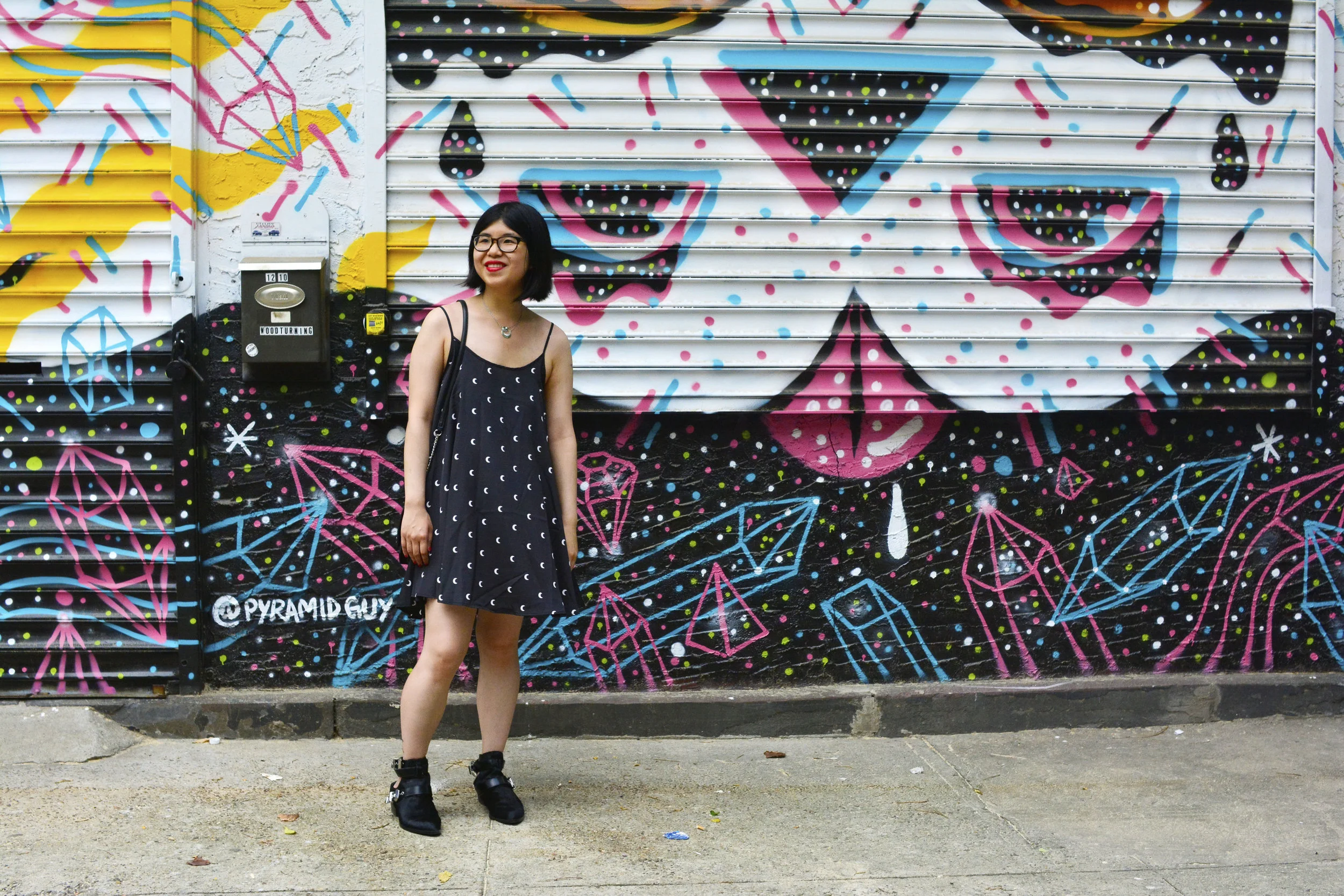 Discovering graffiti at the Welling Mural Court Project in Queens, NYC with a moon print dress, Sol Sana cut-out ankle boots, and ZARA crossbody bag with patches.