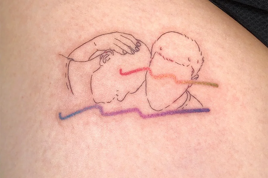 Tattoo Artist: Ariel W A rendering of a scene from my favorite film, Moonlight accompanied by waves in the colors of In The Mood for Love . In Moonlight and In The Mood for Love, each film features a couple sharing silence in each other’s company. The films feel fitting for my own quiet demeanor. In the depicted scene, Chiron doesn’t believe he’s worthy of love but he trusts Kevin enough to allow himself a moment of being cared for. A moment like this, one rife with vulnerability is something I want to welcome into my life.