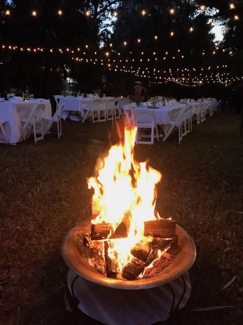 A bonfire blazes at the sun sets at Grow Dat Youth Farm