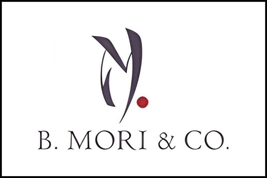 Logo of B. Mori & Co. featuring a stylized 'V' shape and a small red dot above the text.