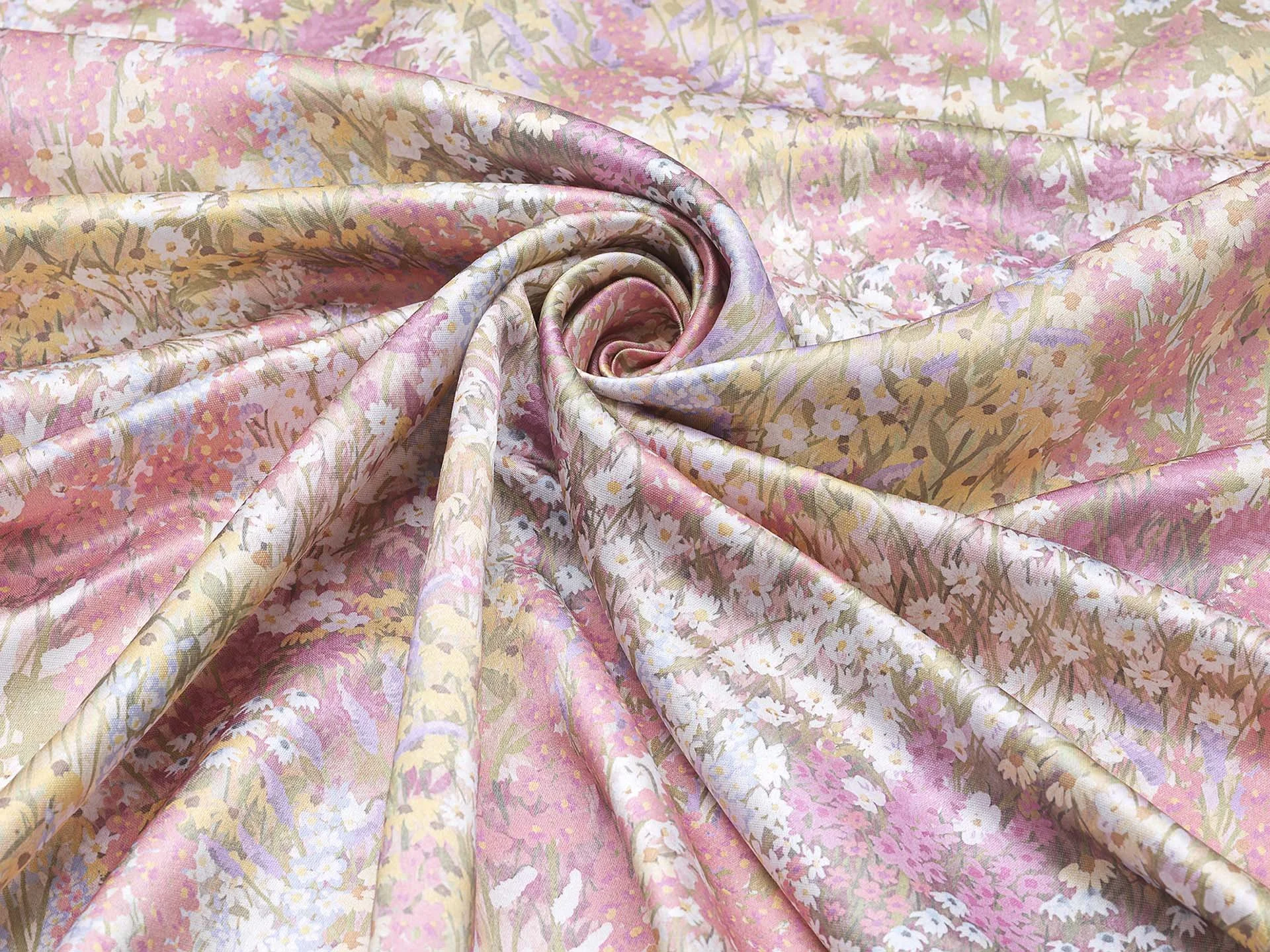 Pink floral fabric with green, white, and purple accents, twisted in a spiral design.