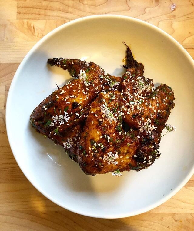 Whole wings | mole | @ansonmills benne seed | herbs | The wings were brined for 24 hours with citrus and aromatics. Dried on a rack the next day for a few hours so the skin can tighten up for a crunchier texture.Then I fried them in a mixture of pork