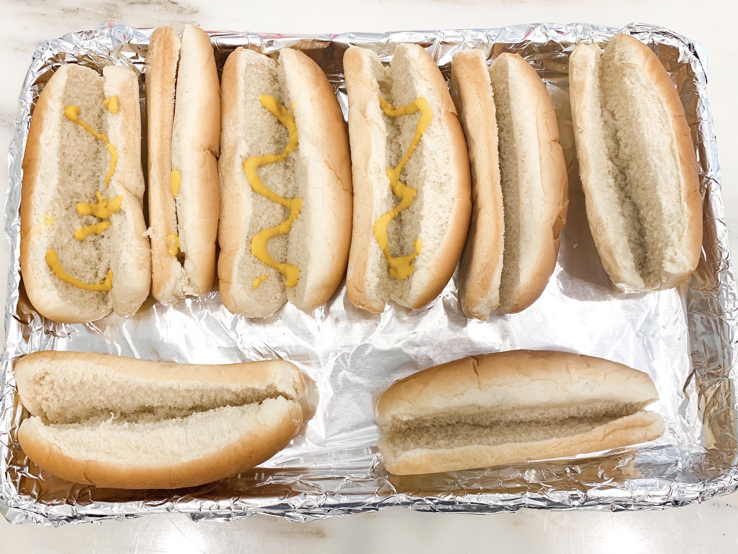 Step 1: Add mustard to the buns.
